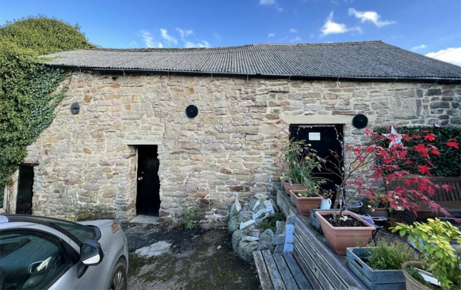 Converted pub with unconverted  barn  in Tansley near Matlock