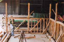 An oak and elm barn frame, repaired, dismantled and labelled and located near Bures in Suffolk